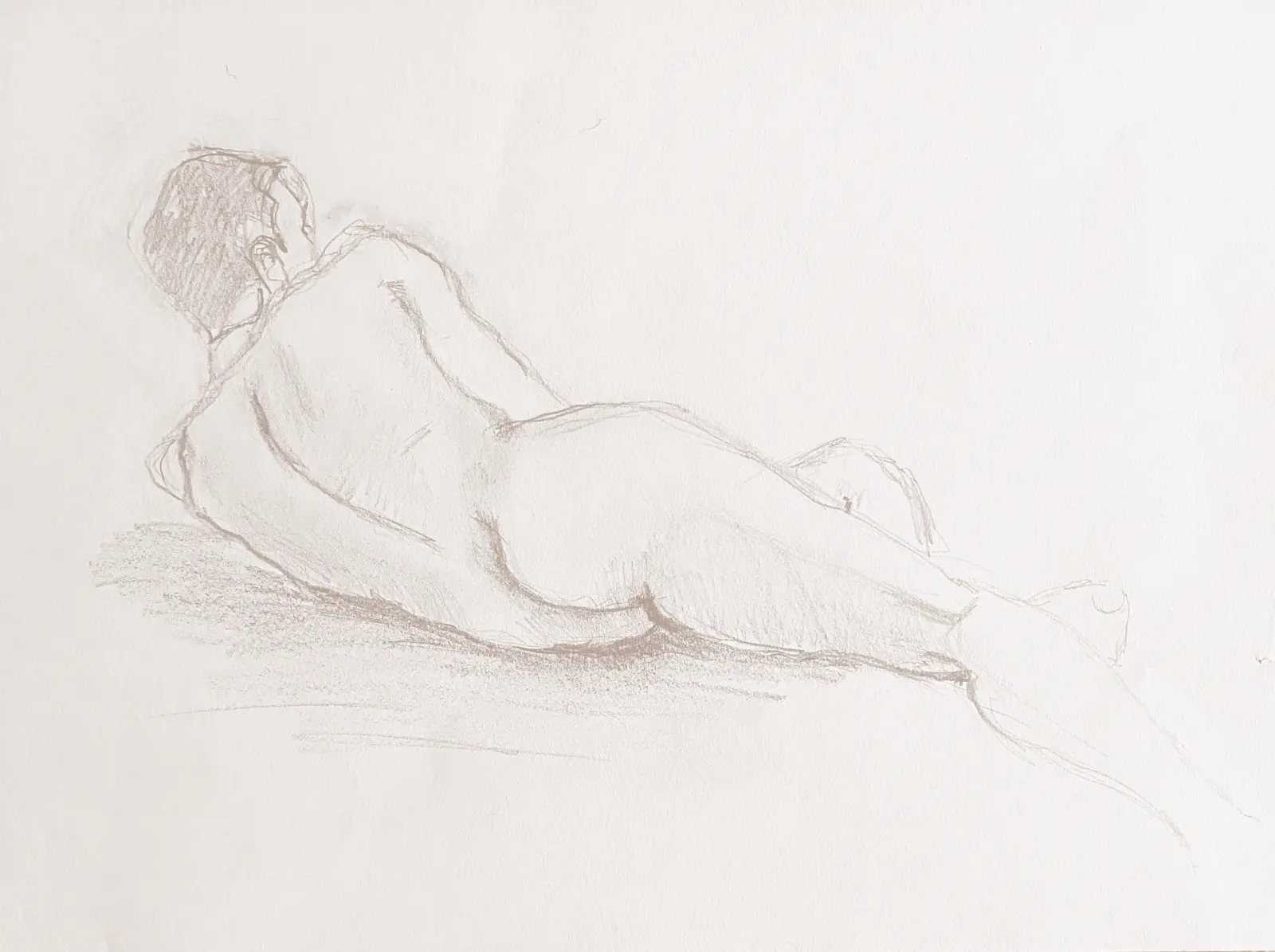 Disegno a matita di figura umana sdraiata, studio dal vero su carta chiara.